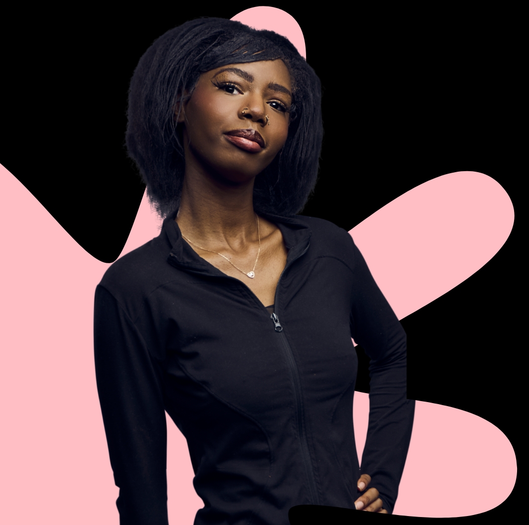 A person in dark clothing stands against a black background with large pink abstract shapes behind them.