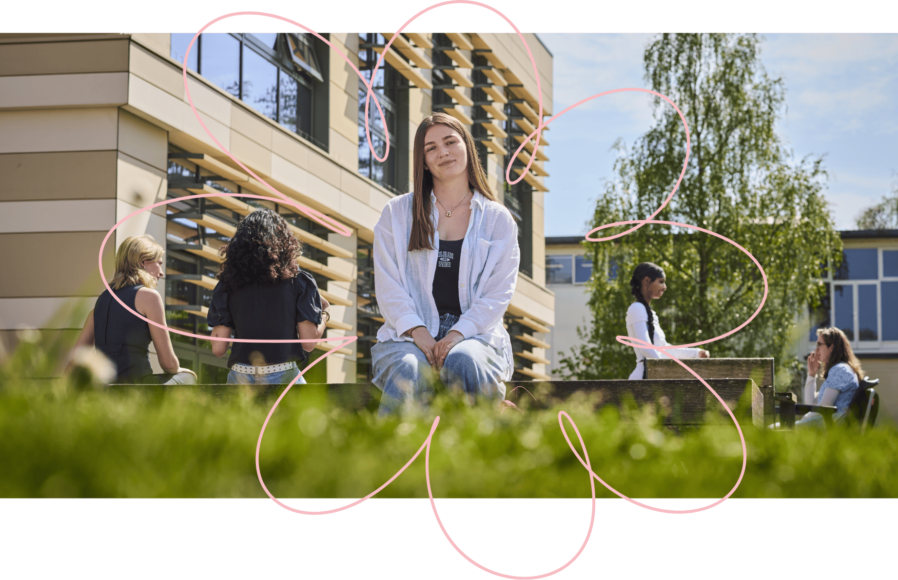 A person sat on a low bench on a sunny day, looking toward the camera, with other people in the background. There is a pink abstract squiggle around the seated person.